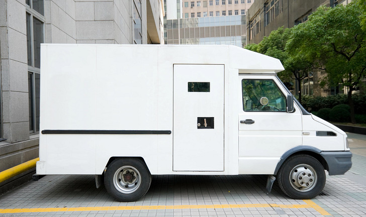 White Armored Car Van Parked in Driveway